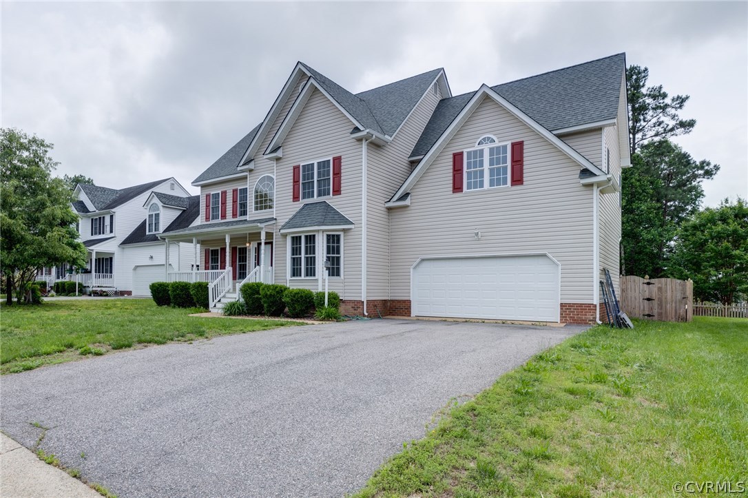 9601 Dunroming Road Chesterfield, VA 23832 - Photo 2 of 34 a front view of a house with a yard and garage