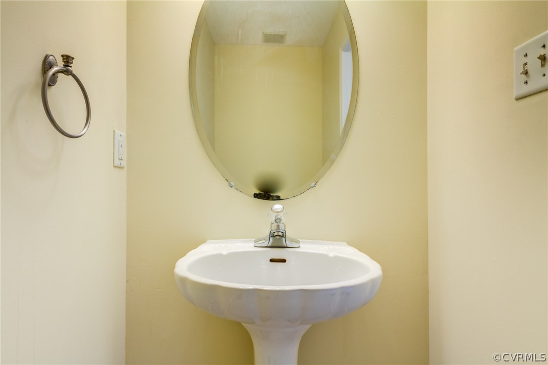 9601 Dunroming Road Chesterfield, VA 23832 - Photo 22 of 34 a bathroom with a sink and a mirror