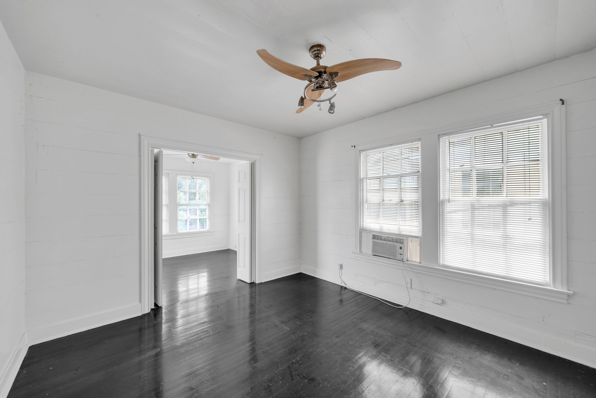 1947 Richmond Avenue, Unit B Houston, TX 77098 - Photo 5 of 12 a view of empty room with wooden floor and fan