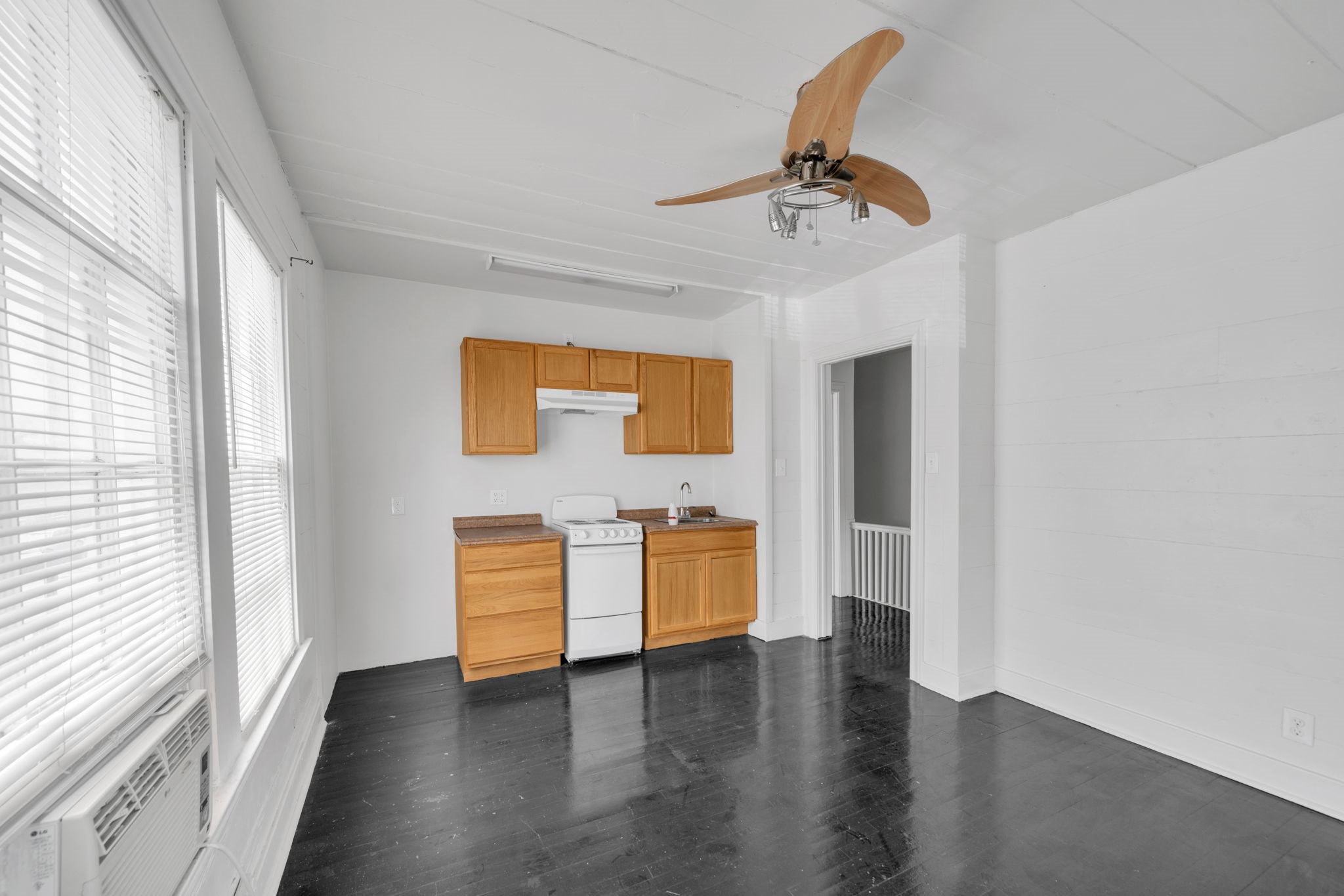 1947 Richmond Avenue, Unit B Houston, TX 77098 - Photo 7 of 12 wooden floor in an empty room with a window