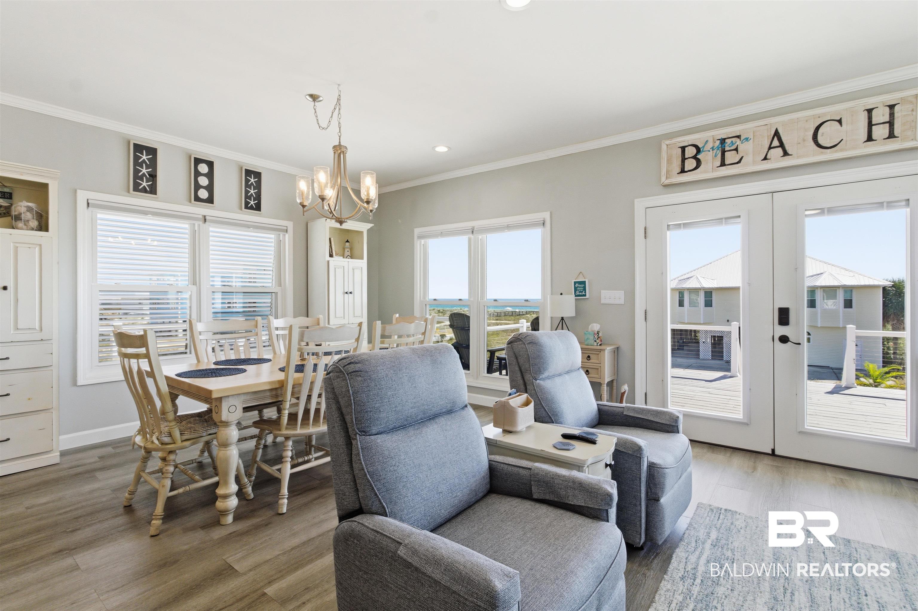418 Veterans Road Gulf Shores, AL 36542 - Photo 36 of 51 Dining room with french doors, crown molding, light wood finished floors, recessed lighting, and a chandelier
