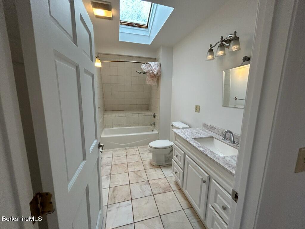 4 Olson Road Florida, MA 01247 - Photo 22 of 29 a bathroom with a granite countertop sink a toilet a mirror and shower