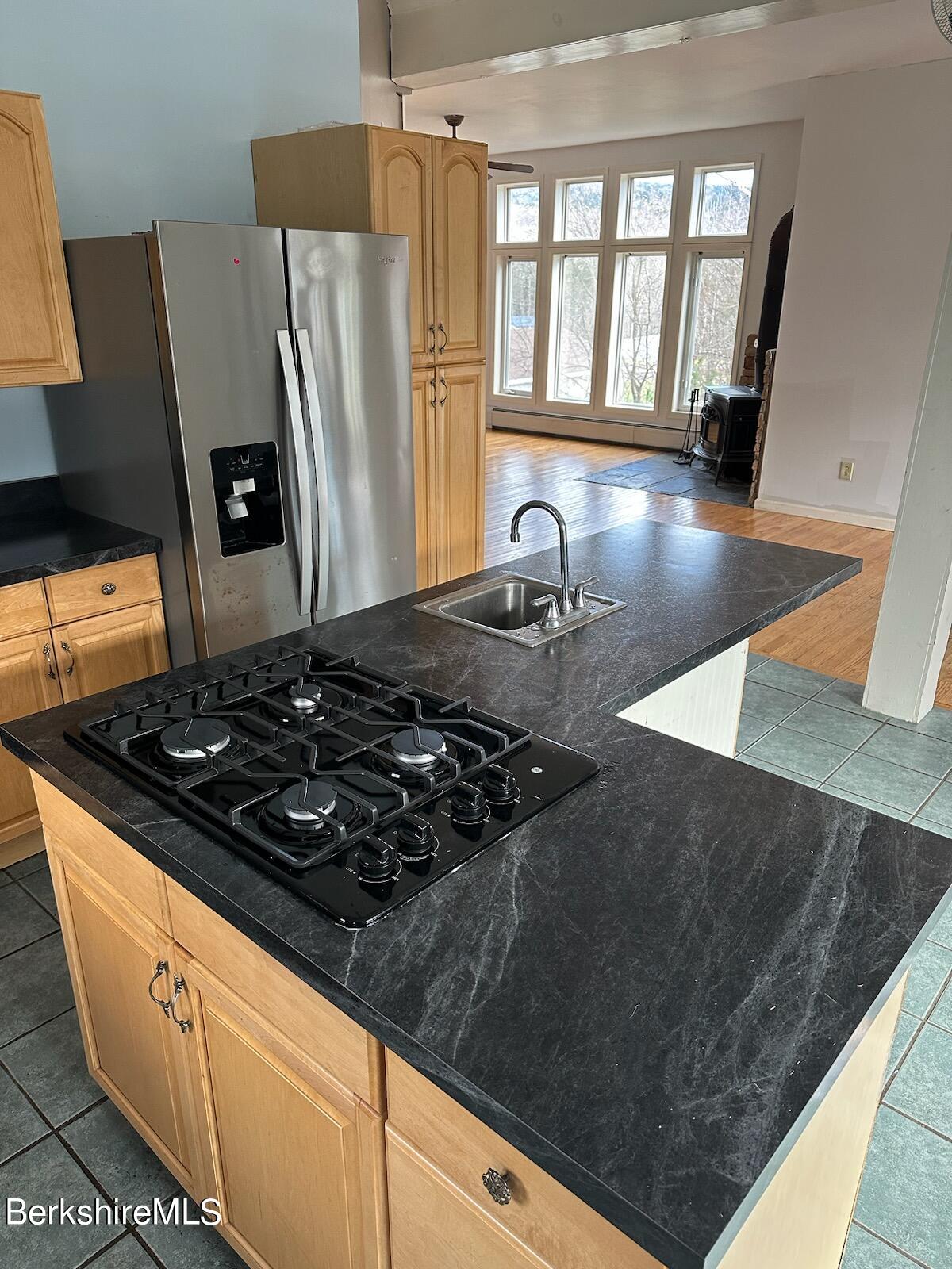4 Olson Road Florida, MA 01247 - Photo 5 of 29 a kitchen with a stove a refrigerator and a wooden floor