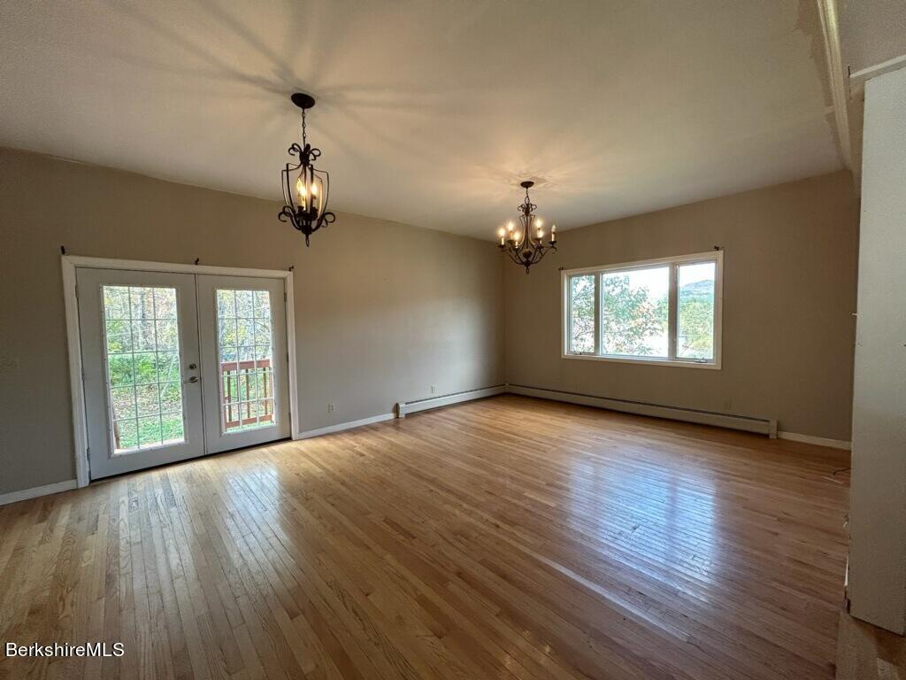 4 Olson Road Florida, MA 01247 - Photo 9 of 29 a view of an empty room with wooden floor and a window