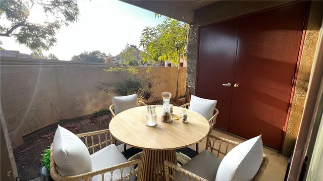 a view of a balcony dining table and chairs