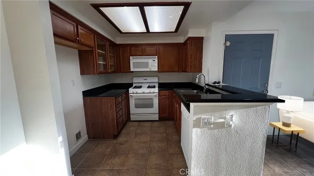 a kitchen with a sink a stove and a refrigerator
