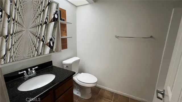 a bathroom with a sink vanity mirror and toilet