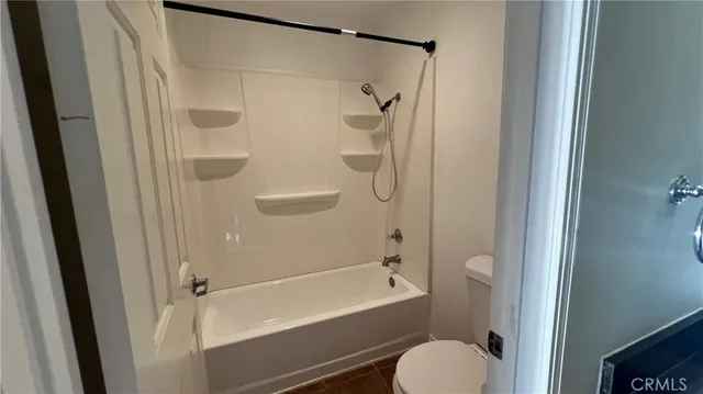 a bathroom with a shower and a toilet