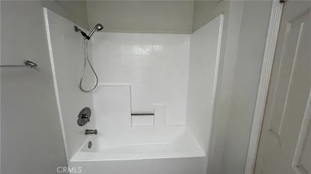 a bathroom with a bath tub with a shower