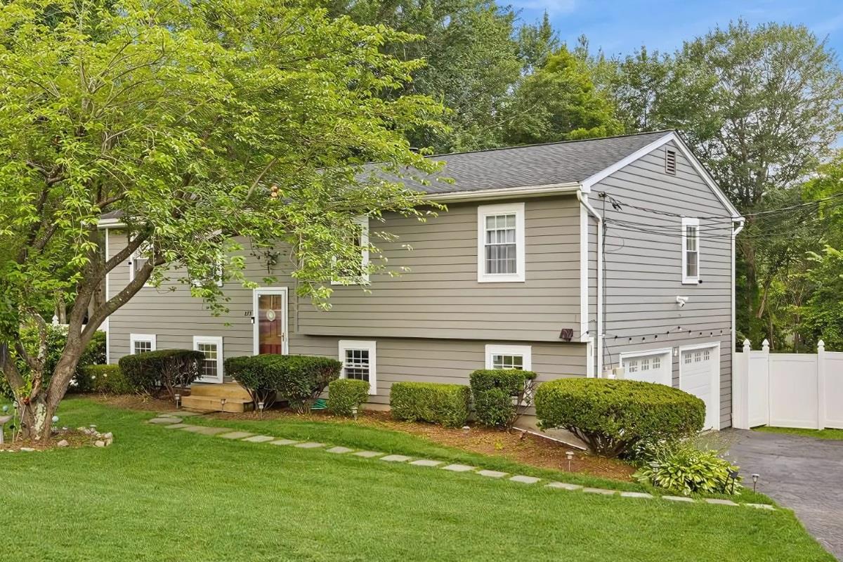 View of front of property featuring driveway and an attached garage