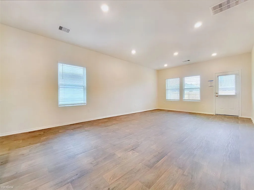 419 Sickle Loop Kyle, TX 78640 - Photo 12 of 35 A spacious, naturally illuminated room boasts recessed lighting and durable wood flooring.