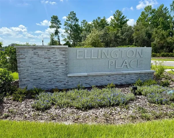 a view of sign board and green space