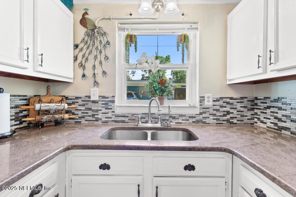 1810 Griflet Road Jacksonville, FL 32211 - Photo 11 of 42 a kitchen with a sink cabinets and a window