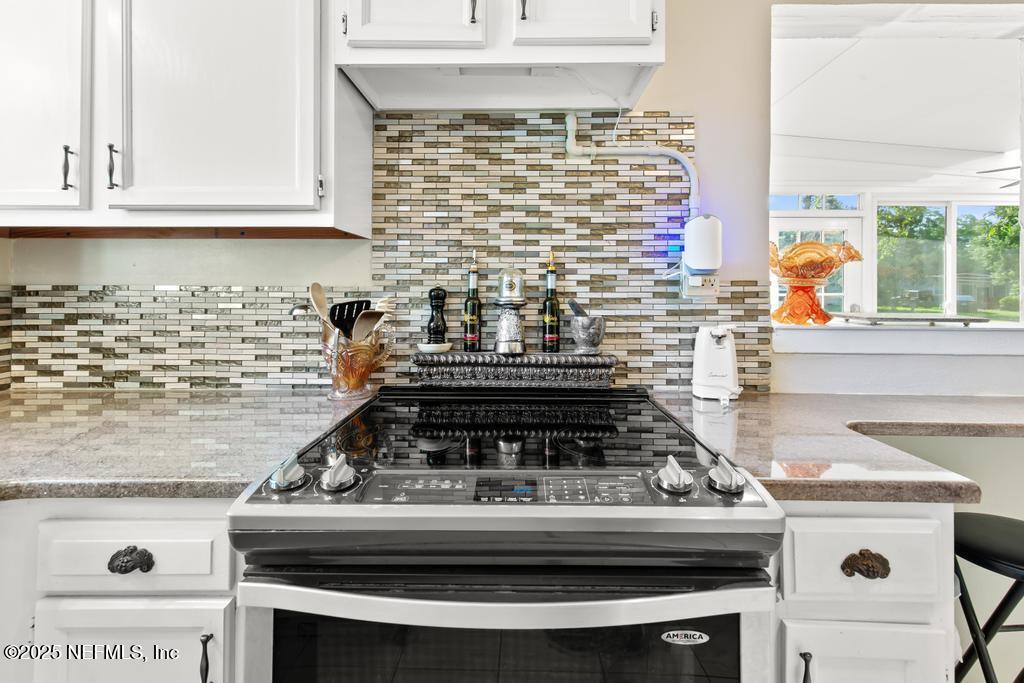 1810 Griflet Road Jacksonville, FL 32211 - Photo 12 of 42 a stove top oven sitting inside of a kitchen