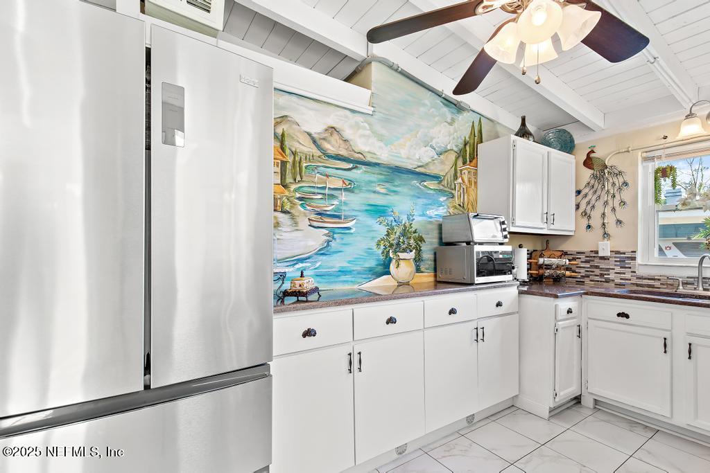 1810 Griflet Road Jacksonville, FL 32211 - Photo 13 of 42 a kitchen with white cabinets and window