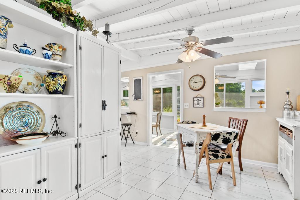 1810 Griflet Road Jacksonville, FL 32211 - Photo 15 of 42 a view of a dining room with furniture and a large window