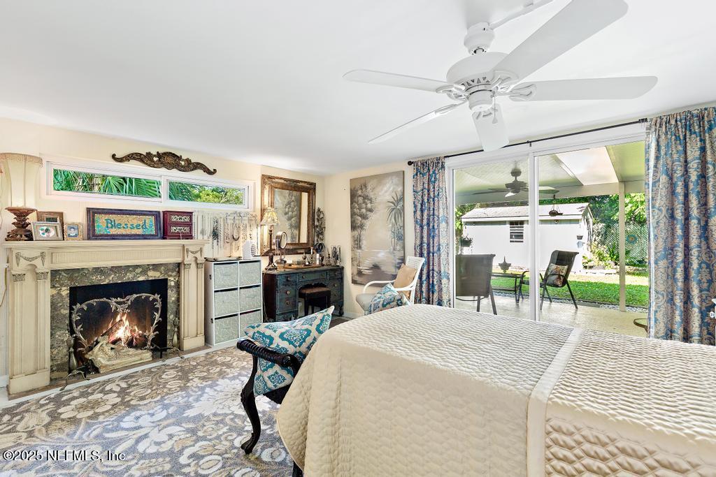 1810 Griflet Road Jacksonville, FL 32211 - Photo 19 of 42 a bedroom with a bed and a fireplace