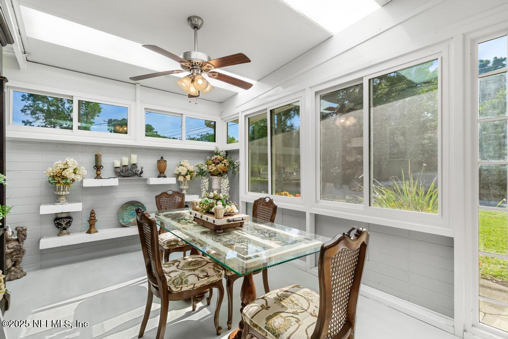 1810 Griflet Road Jacksonville, FL 32211 - Photo 8 of 42 a dining room with furniture a rug and a large window