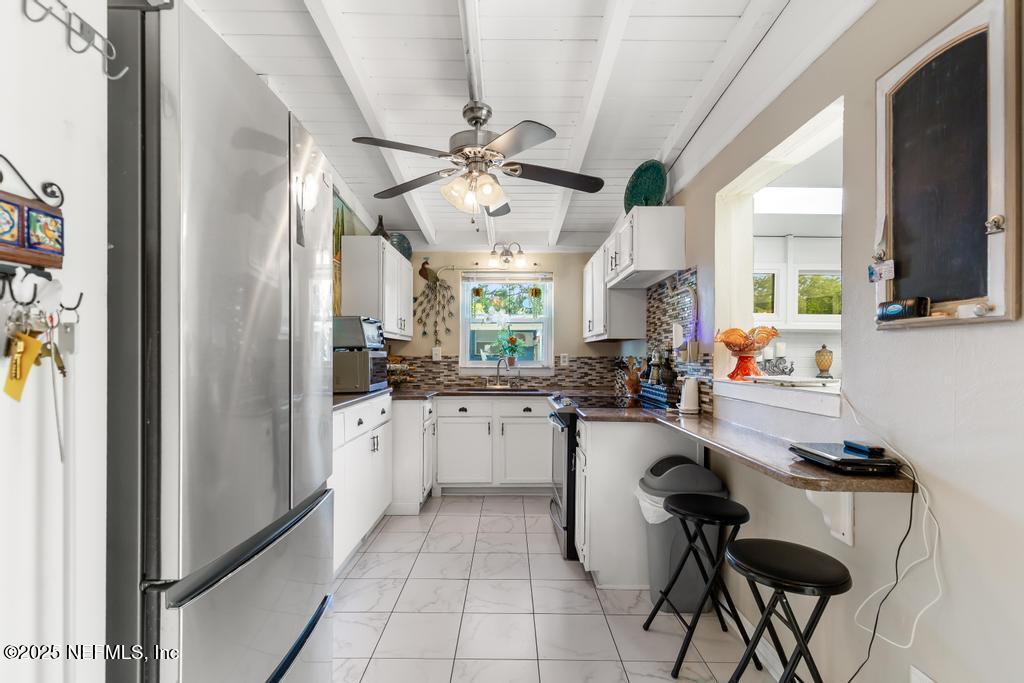 1810 Griflet Road Jacksonville, FL 32211 - Photo 10 of 42 a kitchen with a sink cabinets and window