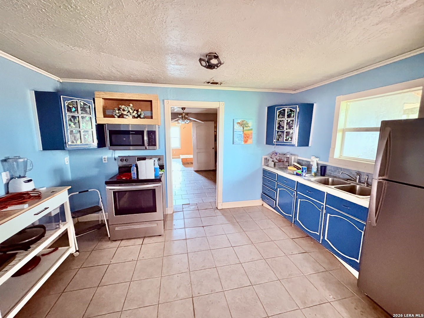 3233 Yucca Loop Eagle Pass, TX 78852 - Photo 3 of 11 a kitchen with stainless steel appliances a stove a sink and a refrigerator