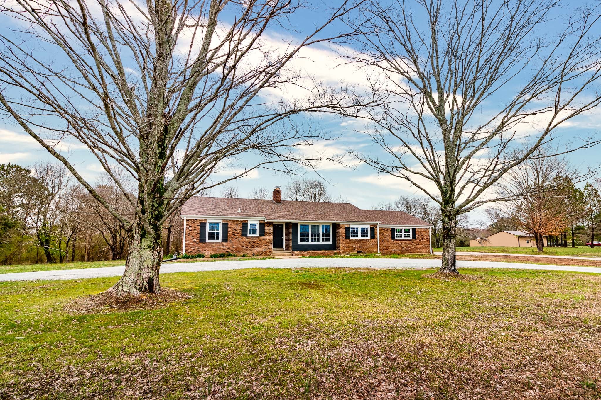 1031 Marable Road Lawrenceburg, TN 38464 - Photo 1 of 27 a front view of a building with trees around
