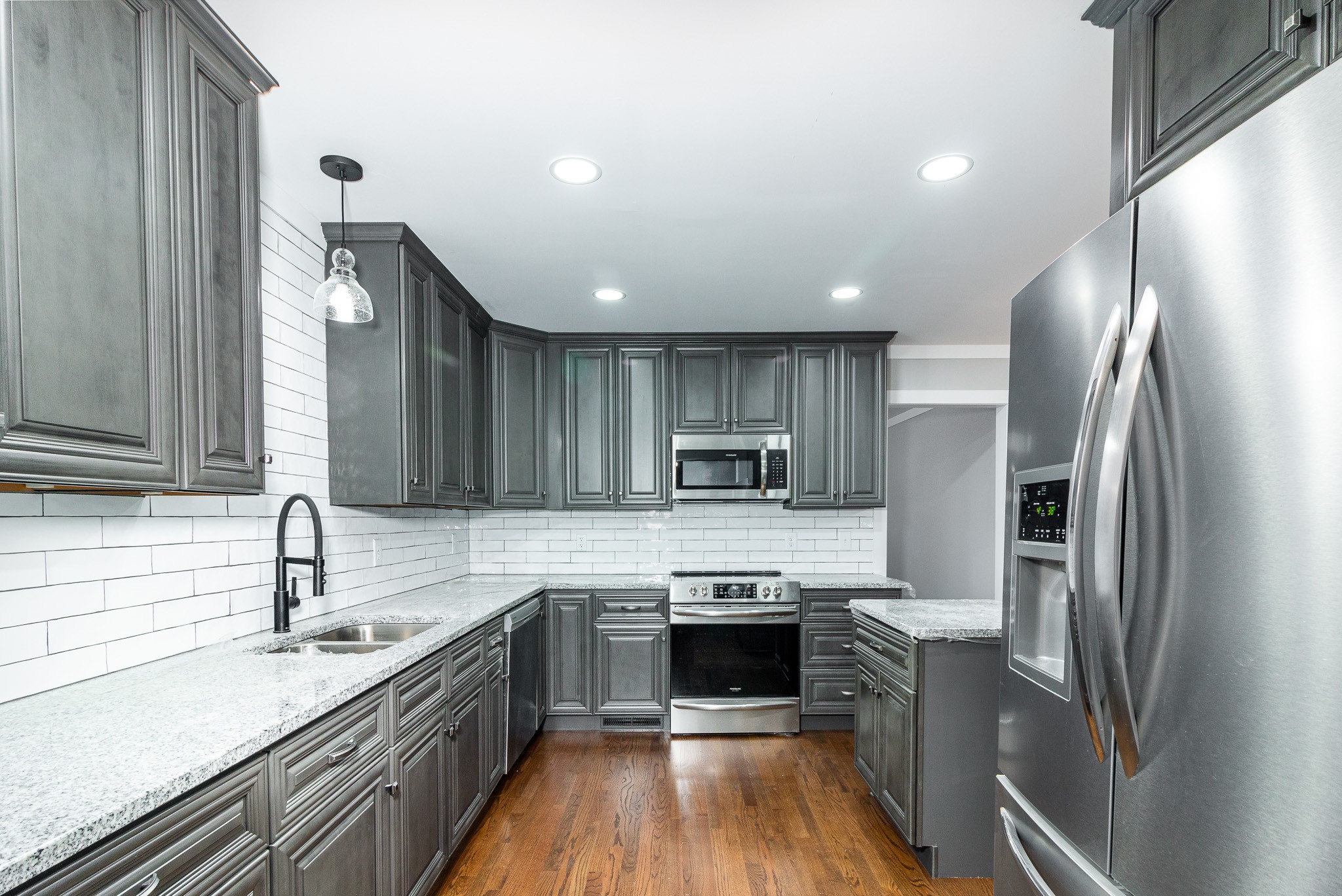 1031 Marable Road Lawrenceburg, TN 38464 - Photo 8 of 27 a kitchen with stainless steel appliances granite countertop a sink stove and refrigerator
