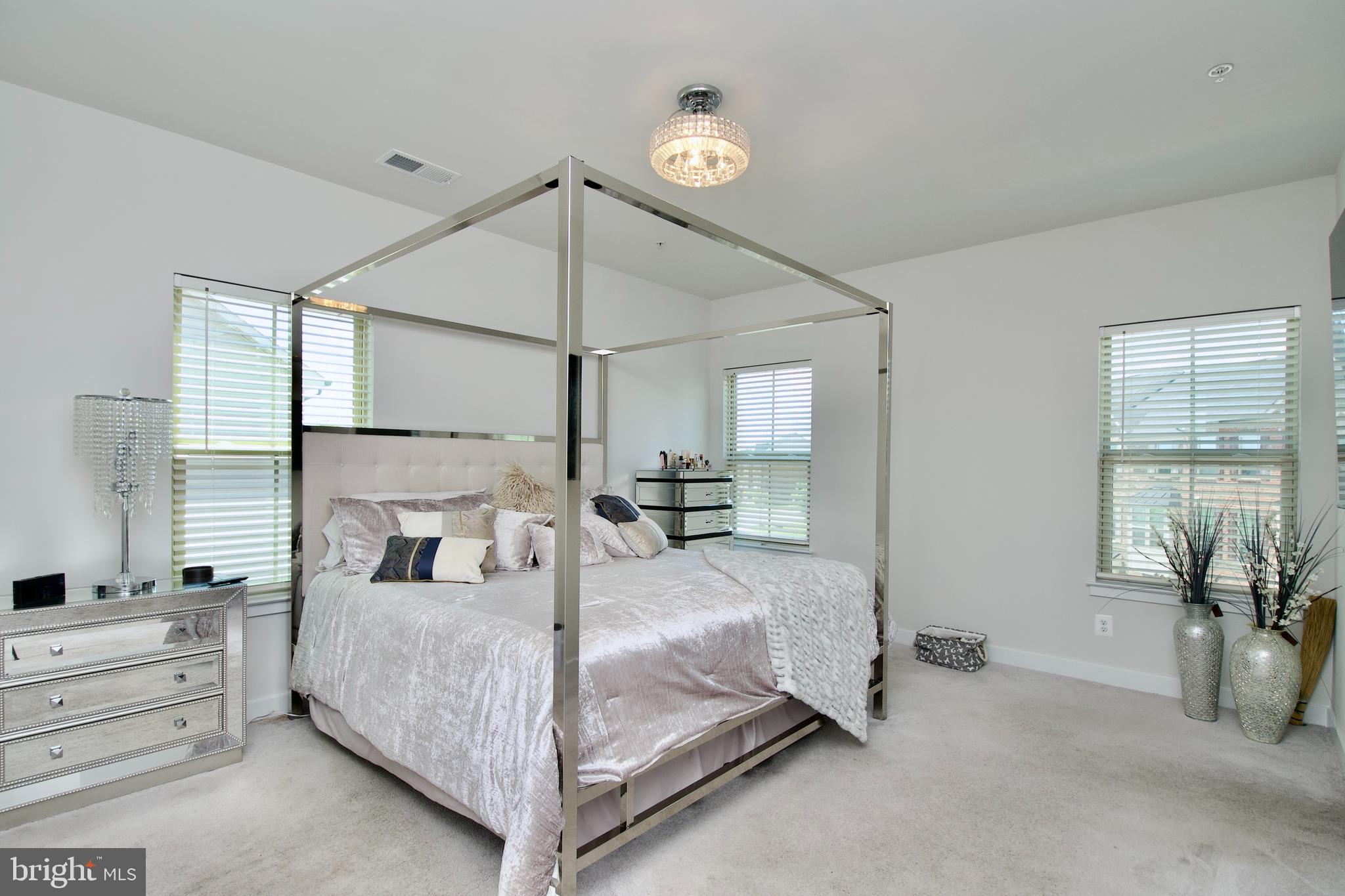 10810 Norbourne Farm Road Upper Marlboro, MD 20772 - Photo 18 of 38 a bedroom with a bed and a chandelier