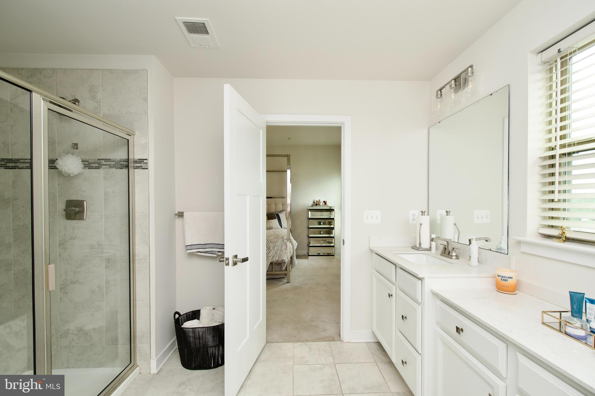 10810 Norbourne Farm Road Upper Marlboro, MD 20772 - Photo 20 of 38 a spacious bathroom with a shower sink and mirror