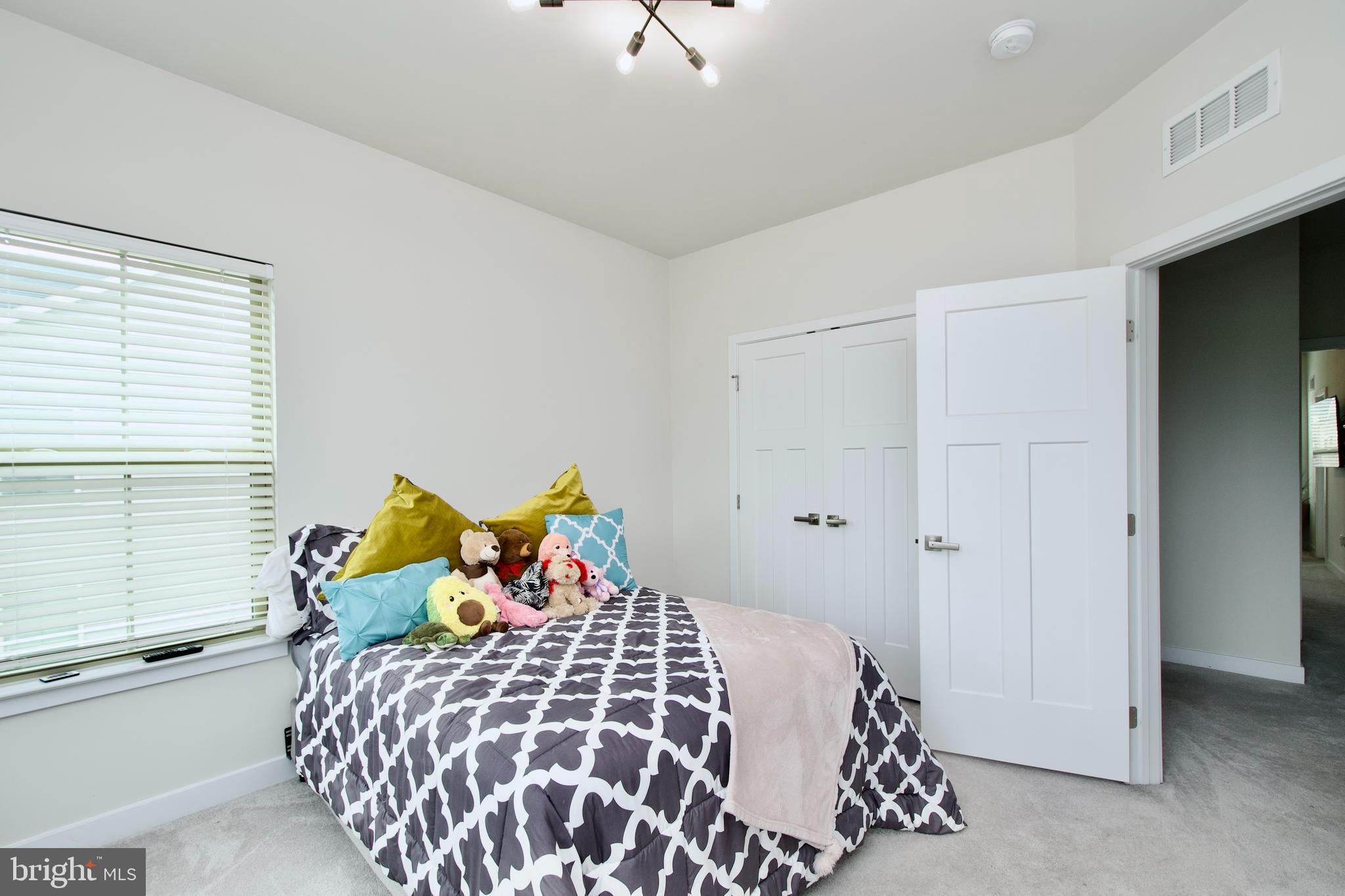 10810 Norbourne Farm Road Upper Marlboro, MD 20772 - Photo 22 of 38 a bedroom with a bed and a window