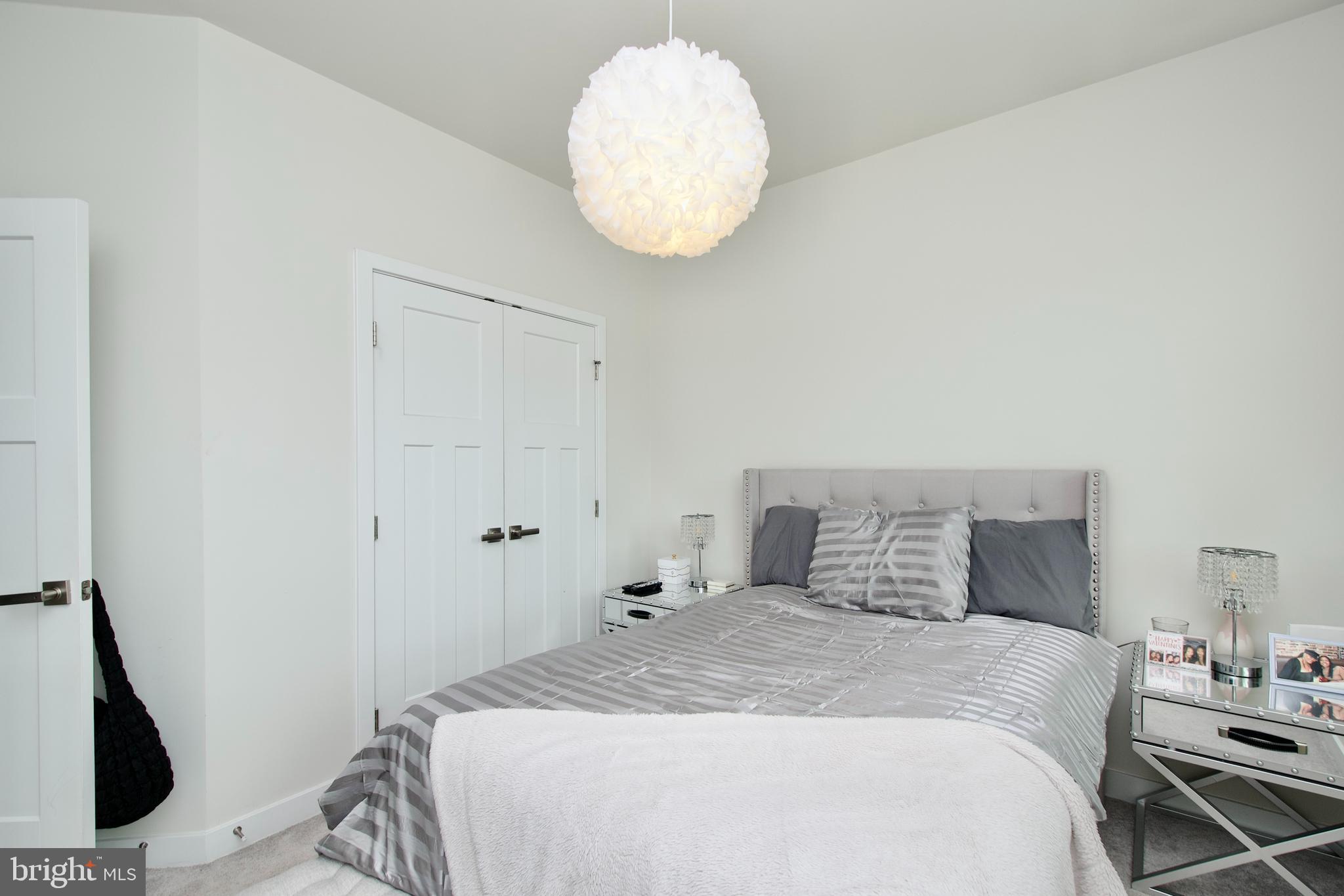 10810 Norbourne Farm Road Upper Marlboro, MD 20772 - Photo 23 of 38 a bedroom with a bed and a chandelier