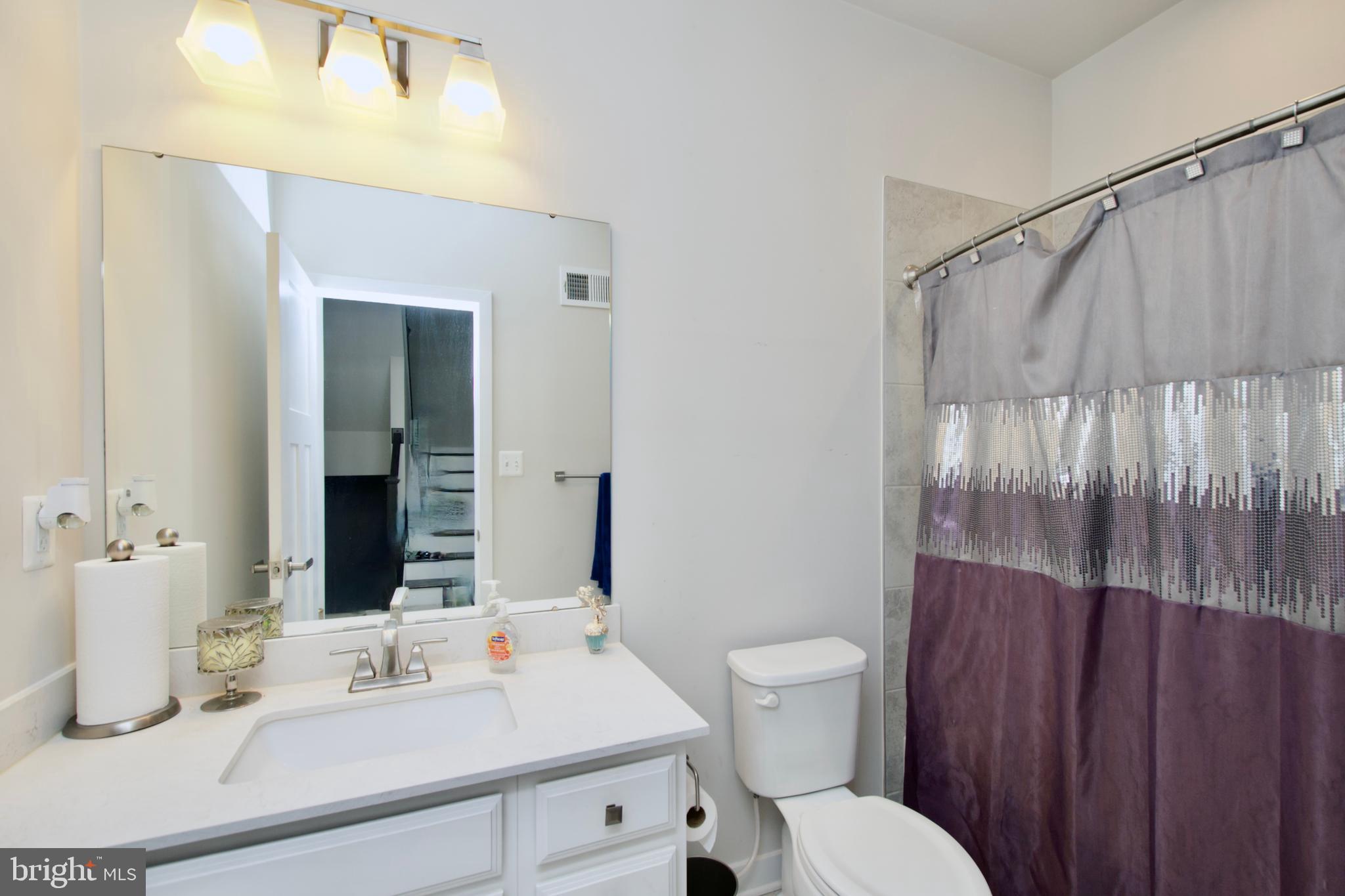 10810 Norbourne Farm Road Upper Marlboro, MD 20772 - Photo 26 of 38 a bathroom with a sink vanity mirror and toilet