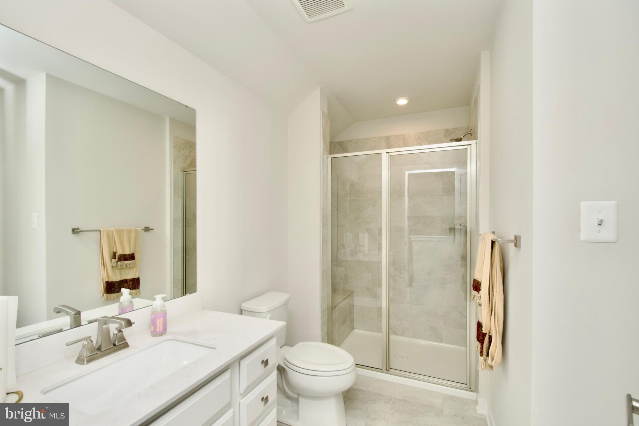 10810 Norbourne Farm Road Upper Marlboro, MD 20772 - Photo 31 of 38 a bathroom with a sink toilet and shower