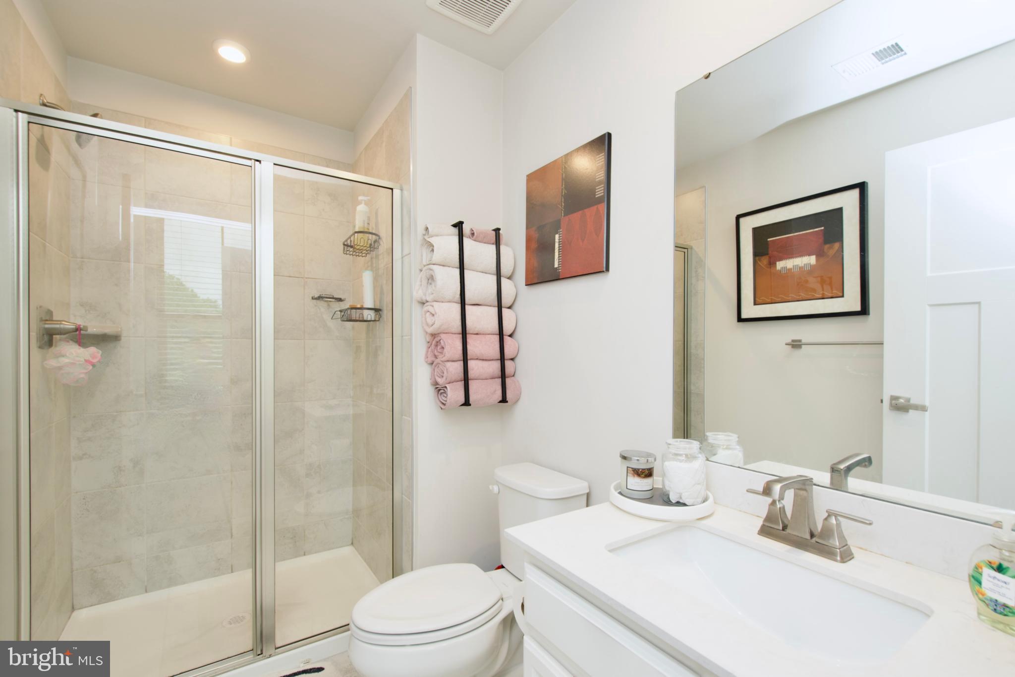 10810 Norbourne Farm Road Upper Marlboro, MD 20772 - Photo 37 of 38 a bathroom with a sink toilet and shower