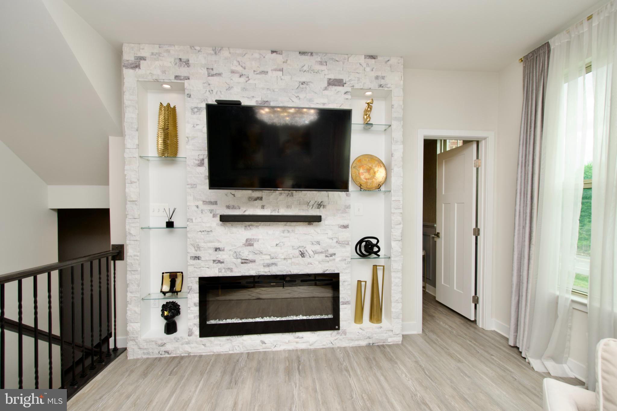 10810 Norbourne Farm Road Upper Marlboro, MD 20772 - Photo 4 of 38 a living room with a fireplace and a flat screen tv