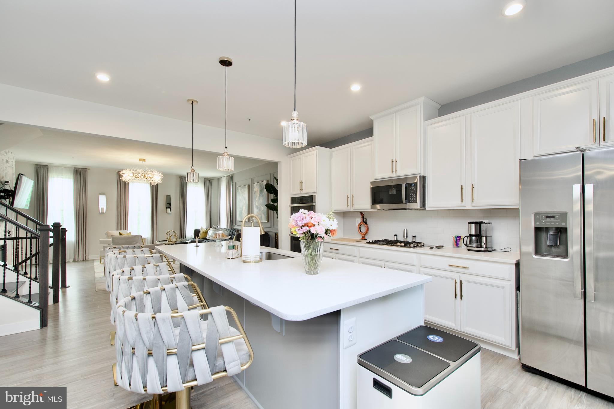 10810 Norbourne Farm Road Upper Marlboro, MD 20772 - Photo 9 of 38 a kitchen with stainless steel appliances kitchen island a white table and chairs in it