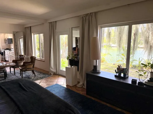 a living room with furniture and large windows