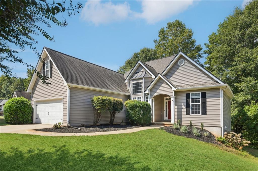 173 Freeman Forest Drive Newnan, GA 30265 - Photo 1 of 35 a front view of a house with a yard and garage