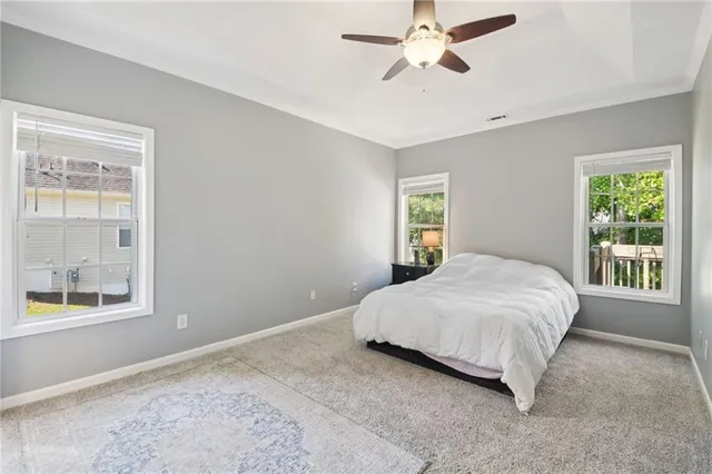 a bedroom with a large bed and a chandelier