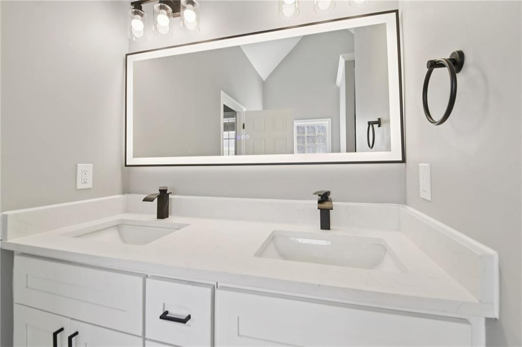 173 Freeman Forest Drive Newnan, GA 30265 - Photo 17 of 35 a bathroom with a sink and a mirror