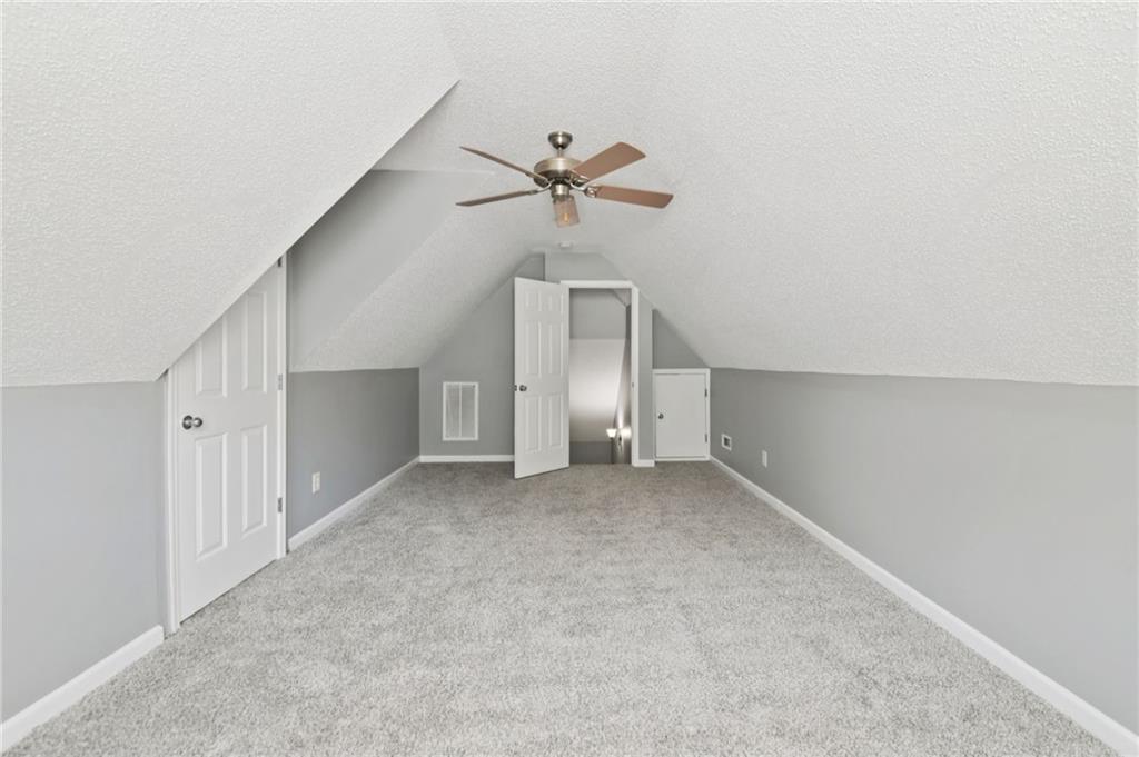 173 Freeman Forest Drive Newnan, GA 30265 - Photo 19 of 35 an empty room with a ceiling fan and a window