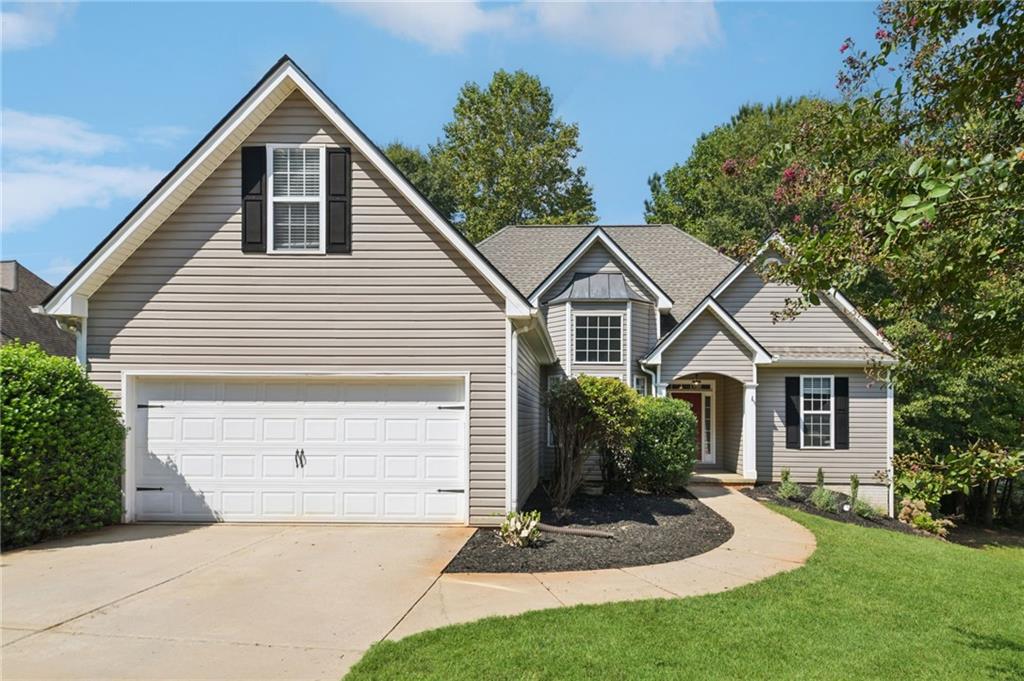 173 Freeman Forest Drive Newnan, GA 30265 - Photo 2 of 35 a front view of a house with a yard and garage