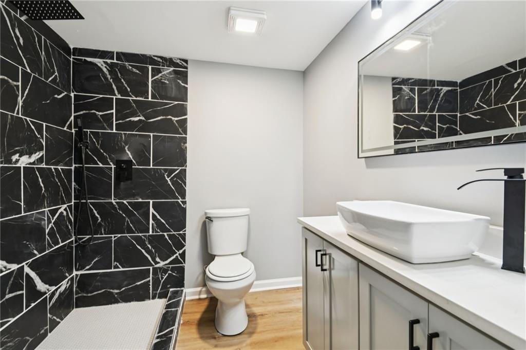 173 Freeman Forest Drive Newnan, GA 30265 - Photo 32 of 35 a bathroom with a sink toilet and shower