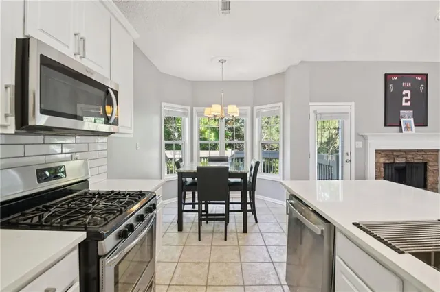 a kitchen with a stove a sink and a microwave