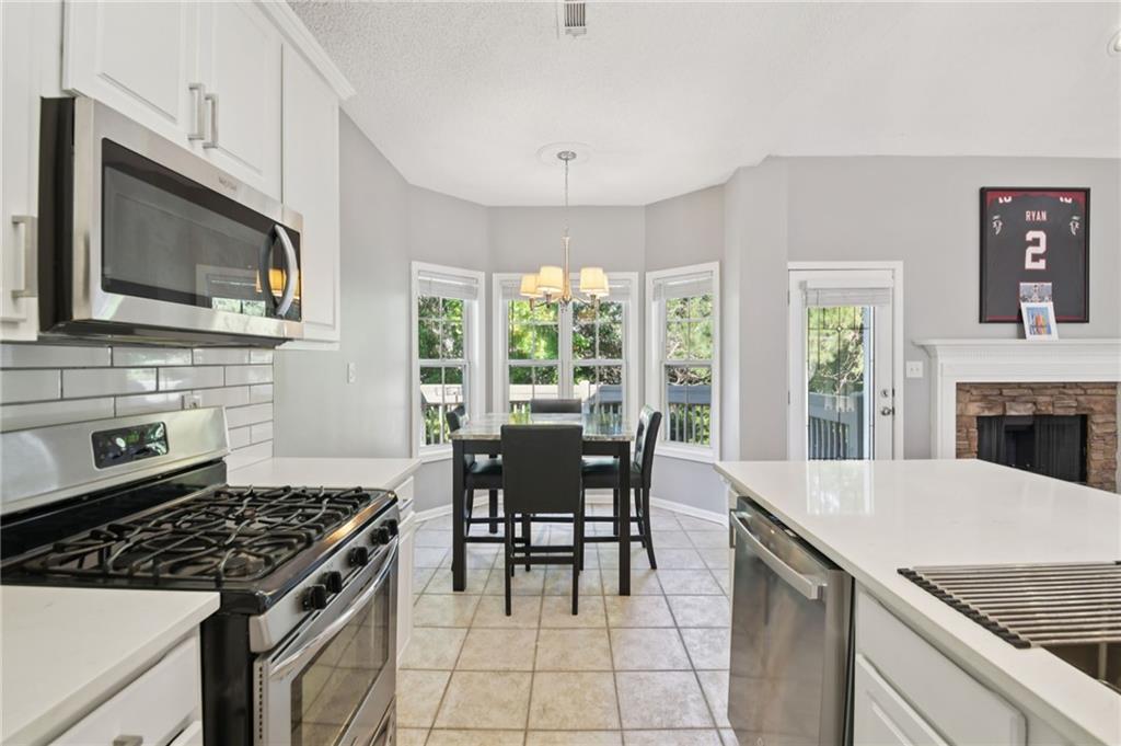 173 Freeman Forest Drive Newnan, GA 30265 - Photo 8 of 35 a kitchen with a stove a sink and a microwave