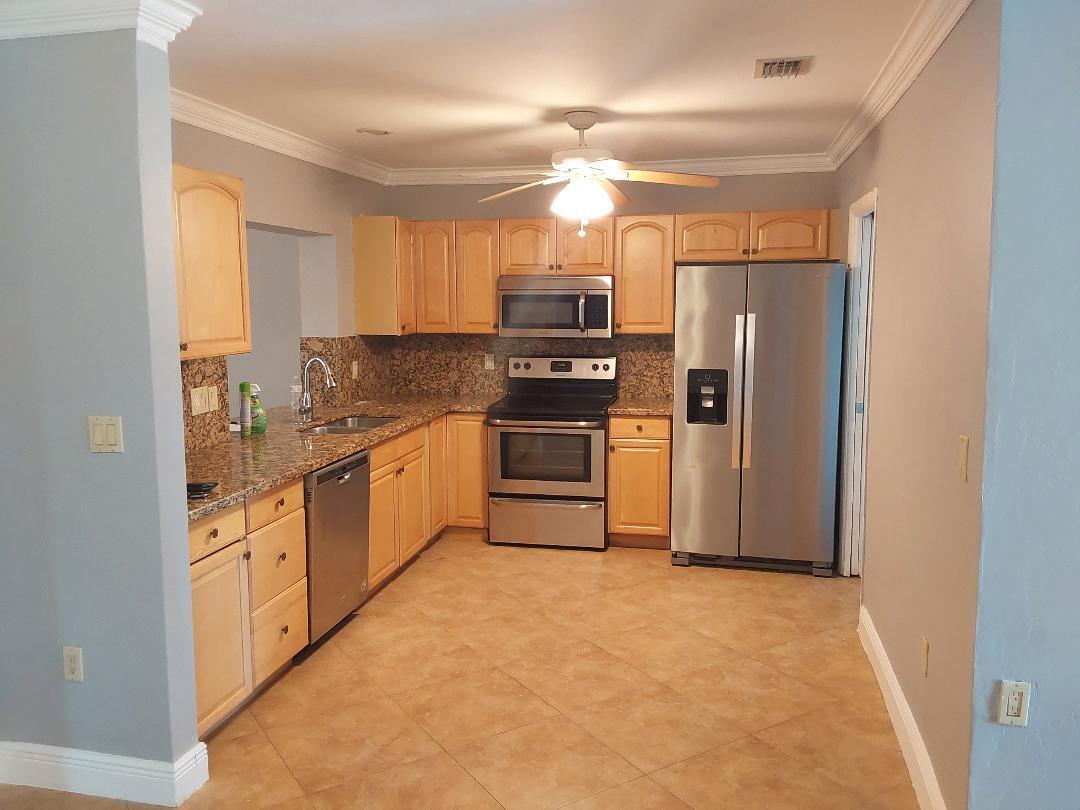 98 Seminole Lane Boca Raton, FL 33487 - Photo 39 of 42 a kitchen with stainless steel appliances a refrigerator a stove a sink and a refrigerator