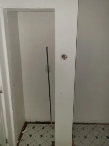 a view of a small space with wooden floor and a window