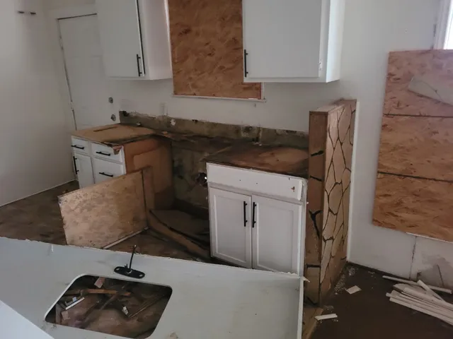 a kitchen with a sink cabinets and window