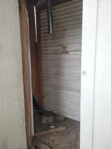 a room with a wooden floor and a cabinet