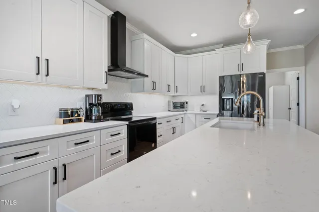 a kitchen with stainless steel appliances a refrigerator sink and cabinets