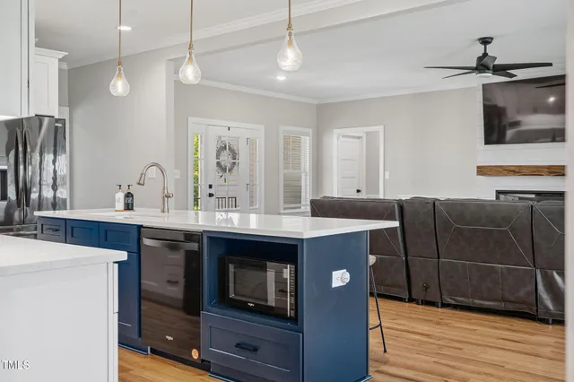 a kitchen with a sink and a stove top oven